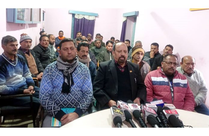 Senior Trade Union leader Som Nath flanked by others addressing press conference at Udhampur.