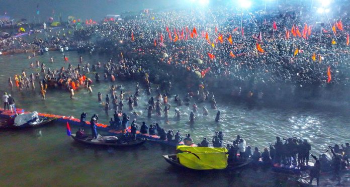 Devotees take a holy dip in river Ganga on the occasion of first 'Amrit Snan' at Kumbh Mela in Prayagraj on Tuesday.(UNI)