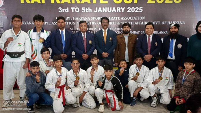 Dignitaries pose alongside Karate players during the North West Kai Karate Cup 2025 at Kurukshetra.