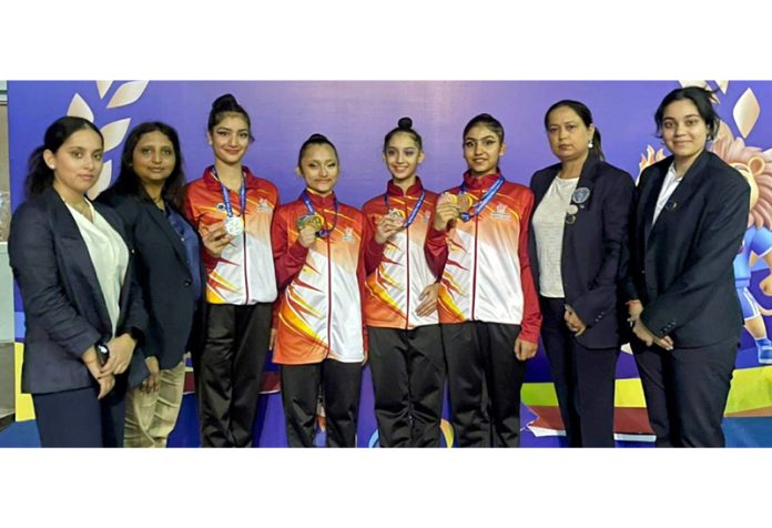 J&K gymnasts posing along with medals and coaching staff at Surat, Gujarat.