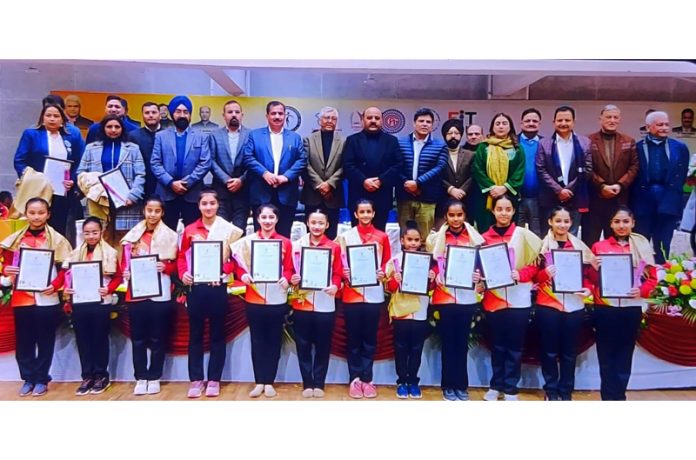 Dignitaries posing with gymnasts during opening ceremony of the National Aerobic Gymnastics Championship at MA Stadium, Jammu.