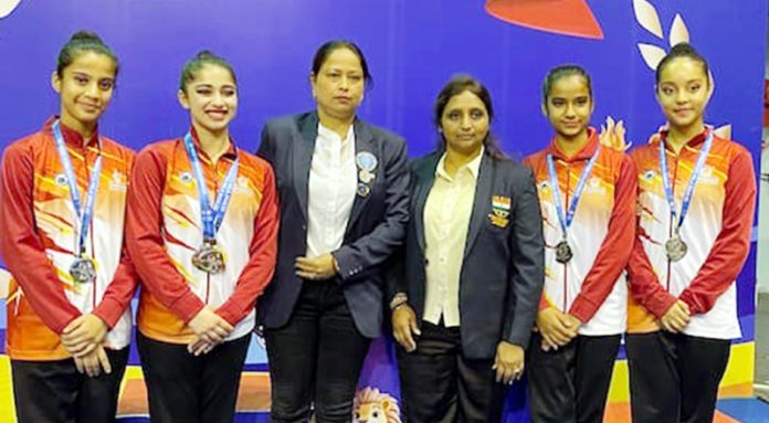 Junior J&K Gymnastics team posing along with coaching staff at Surat.