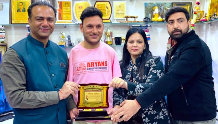 Para Cricketer Amir Hussain Lone receiving a memento from management of Aryans Group of Colleges.