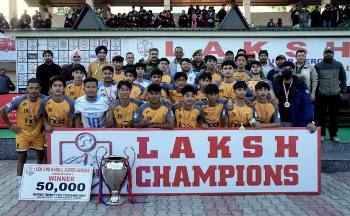 Winning team Realona FC Kargil, posing with the trophy alongside dignitaries during the prize distribution ceremony at Mini Stadium, Parade, Jammu on Wednesday.