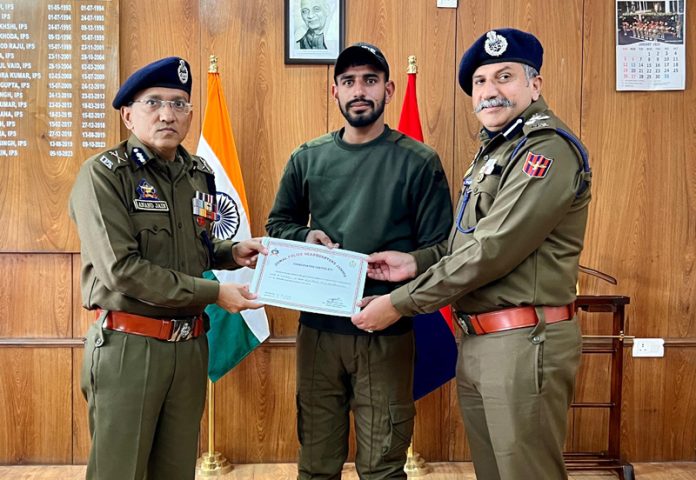 ADGP Jammu Anand Jain and DIG JSK Range Shiv Kumar Sharma awarding an officer in Jammu on Wednesday.