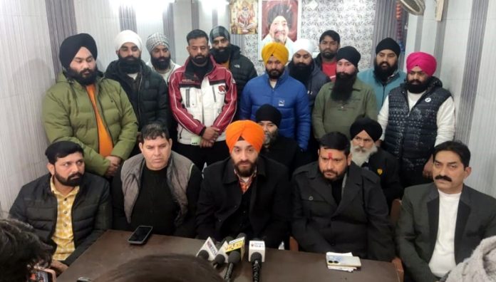 AJKTWA Chairman, Karan Singh Wazir flanked by others addressing press conference in Jammu.