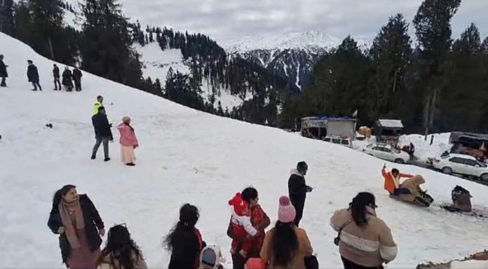 Tourists enjoying snow in Bhaderwah on Saturday.