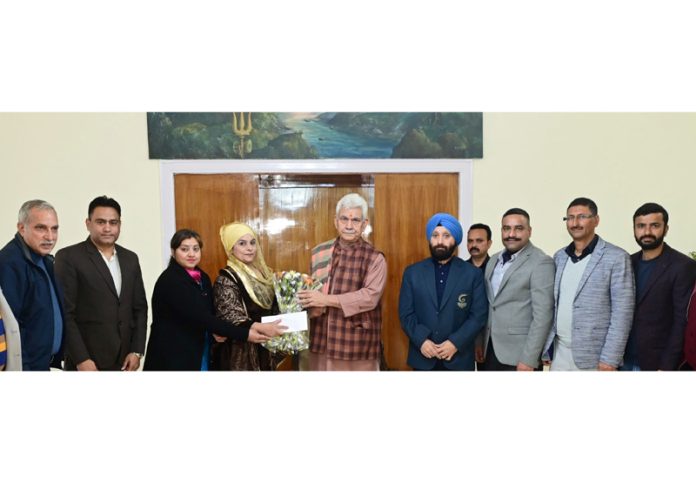 LG Manoj Sinha posing with a delegation of J&K Masters Games Association at Raj Bhawan, Jammu.