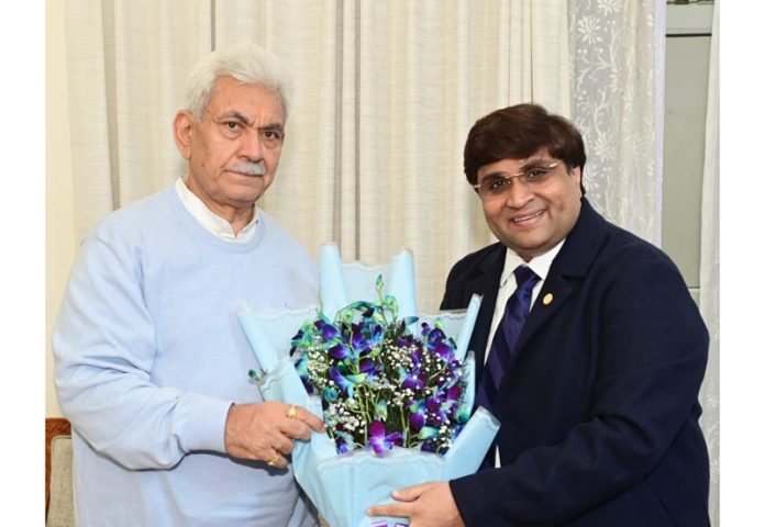 Rahul Sahai presenting a flower bouquet to LG Manoj Sinha at Raj Bhawan Jammu on Tuesday.