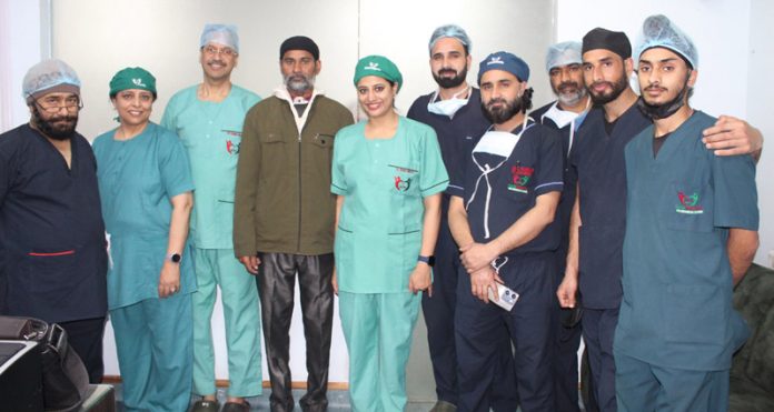 A patient who underwent a surgery for rare laryngeal cancer along with doctors who performed the procedure at Pulse Hospital Jammu.