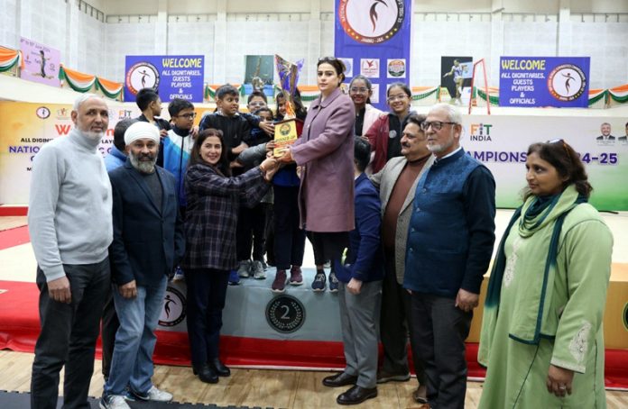 Title winners Maharashtra receiving trophy from dignitaries during prize distribution ceremony.