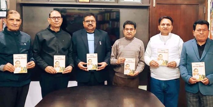 Balbir Ram Rattan distributing books on Constitution of India during a programme in Jammu on Monday.