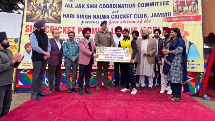 Dignitaries presenting 'Man of the Match' cheque to player during a post match session in Jammu.