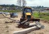 A JCB demolishes plinth during special operation by JDA at Ragoora in Sidhra on Tuesday.