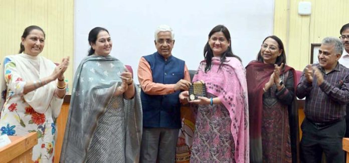 VC JU Prof Umesh Rai honouring a NAAC Coordinator in presence of other officers.