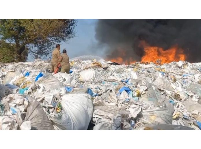 Firefighters trying to control the blaze in a scrap godown in Samba district on Tuesday.