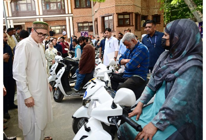 CM Omar Abdullah presenting scooties among specially-abled people in Ganderbal.