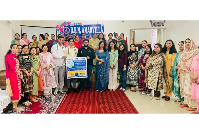 Doctors posing along with teaching staff of DBN Amarvilla during a health awareness session.