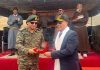 An officer presenting memento to a dignitary.
