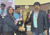 Utkarsh Gupta along with coaching staff Rita Rehan and Madhu Sharma posing with Roll Ball World Cup 2025 trophy.
