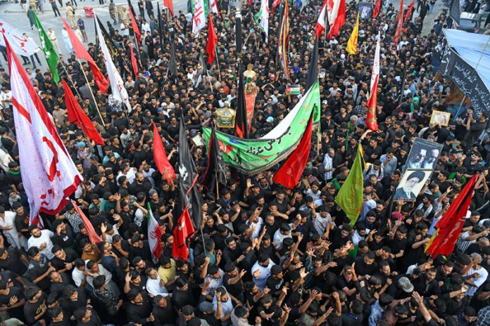 Mourners marching during 8th Muharram procession in Srinagar on Friday. — Excelsior/Shakeel