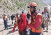 A pilgrim being helped by a cop near holy cave after she suffered breathlessness.