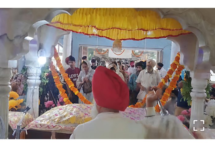 Devotees offering prayers at Gurdwara Talab Tillo in Jammu on Saturday.