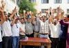 J&K Road Transport Corporation employees raising slogans after meeting on Monday. — Excelsior/Shakeel